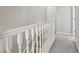 Upstairs hallway with railing and carpeted floors at 208 Hembree Park Ter, Roswell, GA 30076