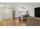 Modern kitchen featuring stainless steel appliances, white cabinetry, a kitchen island with bar stools, and hardwood floors at 208 Hembree Park Ter, Roswell, GA 30076