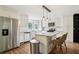 Bright kitchen with white cabinets, stainless steel appliances, granite countertops, and modern pendant lighting at 208 Hembree Park Ter, Roswell, GA 30076