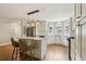 Open concept kitchen with a center island, white cabinets, stainless steel appliances, and hardwood floors at 208 Hembree Park Ter, Roswell, GA 30076