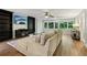 Comfortable living room featuring hardwood floors, a large sectional couch, and built-in bookcases at 208 Hembree Park Ter, Roswell, GA 30076