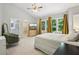 Sun-filled main bedroom suite featuring a large bed, an accent chair, and backyard views at 208 Hembree Park Ter, Roswell, GA 30076