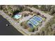 Aerial view of community amenities including a pool and tennis courts near a picturesque lake at 2689 Spring Rock Ne Ct, Roswell, GA 30075