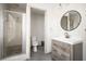 Well-lit bathroom featuring a shower and updated vanity with modern fixtures at 2689 Spring Rock Ne Ct, Roswell, GA 30075
