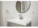 Modern bathroom featuring a sleek vanity, round mirror, and stylish fixtures at 2689 Spring Rock Ne Ct, Roswell, GA 30075