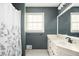 Bathroom featuring a white vanity with black fixtures and a shower with a floral curtain at 2689 Spring Rock Ne Ct, Roswell, GA 30075