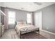 Comfortable bedroom featuring plush carpeting, two windows, and a ceiling fan at 2689 Spring Rock Ne Ct, Roswell, GA 30075
