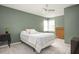 Inviting bedroom with neutral carpet, an olive-green wall, and classic wooden furniture at 2689 Spring Rock Ne Ct, Roswell, GA 30075