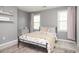 Cozy bedroom with soft gray walls, two windows, and a decorative rug at 2689 Spring Rock Ne Ct, Roswell, GA 30075
