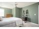 Well-lit bedroom with a ceiling fan, neutral carpet, and a unique shelving unit at 2689 Spring Rock Ne Ct, Roswell, GA 30075