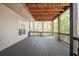 Outdoor deck with finished floor and wood beam ceiling with hanging lights at 2689 Spring Rock Ne Ct, Roswell, GA 30075