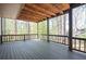 Large outdoor deck with finished floor and wood beam ceiling with hanging lights at 2689 Spring Rock Ne Ct, Roswell, GA 30075