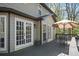 Spacious outdoor deck with seating, patio umbrella, and access through white French doors at 2689 Spring Rock Ne Ct, Roswell, GA 30075
