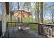 View of the deck featuring outdoor seating with an umbrella overlooking the surrounding greenery at 2689 Spring Rock Ne Ct, Roswell, GA 30075