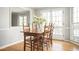 Bright dining room features hardwood floors, wood table set, and natural light from french doors to the balcony at 2689 Spring Rock Ne Ct, Roswell, GA 30075