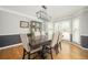 Traditional dining room with dark wood table, updated chandelier, and large windows at 2689 Spring Rock Ne Ct, Roswell, GA 30075