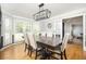 This formal dining room features a large table, wainscoting, and natural light from multiple windows at 2689 Spring Rock Ne Ct, Roswell, GA 30075