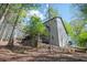 Charming home featuring gray siding, multi-level decks, and surrounded by lush, mature trees at 2689 Spring Rock Ne Ct, Roswell, GA 30075