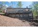 Exterior of home with multi-tiered deck overlooking a wooded backyard at 2689 Spring Rock Ne Ct, Roswell, GA 30075