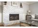 Close-up of the living room fireplace with a wooden mantle and art on the wall at 2689 Spring Rock Ne Ct, Roswell, GA 30075