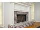 Living area fireplace features brick surround, detailed millwork, and hardwood flooring at 2689 Spring Rock Ne Ct, Roswell, GA 30075