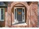 Close-up of a brick front door entrance with a decorative wreath at 2689 Spring Rock Ne Ct, Roswell, GA 30075