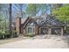 Attractive brick home with a three-car garage and well-manicured landscaping in a desirable neighborhood at 2689 Spring Rock Ne Ct, Roswell, GA 30075