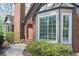 Brick home with bay windows, a front door entrance, and manicured landscaping at 2689 Spring Rock Ne Ct, Roswell, GA 30075