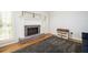 Cozy living room featuring a fireplace, a dollhouse, and hardwood floors at 2689 Spring Rock Ne Ct, Roswell, GA 30075