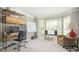 Inviting living room with big windows, modern desk, speakers, and an accent chair at 2689 Spring Rock Ne Ct, Roswell, GA 30075