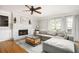 Comfortable living room with hardwood floors, fireplace, and a large gray sectional sofa with a glass table at 2689 Spring Rock Ne Ct, Roswell, GA 30075