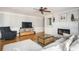 Cozy living room featuring a white brick fireplace and a gray sectional sofa and hardwood floors at 2689 Spring Rock Ne Ct, Roswell, GA 30075