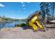 Playground with playhouse, slides, and swingset adjacent to a lake and picnic area at 2689 Spring Rock Ne Ct, Roswell, GA 30075