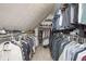 Organized walk-in closet with shelving and hanging space for clothing and shoes at 2689 Spring Rock Ne Ct, Roswell, GA 30075
