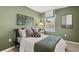Charming bedroom with comfortable bed, green walls, and natural light at 2810 Georgia Aster Nw Way # 6, Atlanta, GA 30318