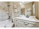 Bathroom showcasing neutral stone tile work, a bathtub and a white vanity at 3405 Camellia Ln, Suwanee, GA 30024