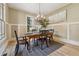 Traditional dining room showcasing a chandelier, warm wood flooring, and a modern painting at 3405 Camellia Ln, Suwanee, GA 30024