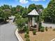 The Wentworth Manor entrance is marked by a stone monument surrounded by lush greenery at 3405 Camellia Ln, Suwanee, GA 30024