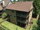 Aerial view of a multi-story house, highlighting the back porch, yard, and surrounding trees at 3405 Camellia Ln, Suwanee, GA 30024
