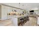 Open kitchen with island seating, stainless appliances, and views into the living area at 3405 Camellia Ln, Suwanee, GA 30024