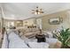 Open concept living area with hardwood floors, a kitchen, and a large comfortable sofa at 3405 Camellia Ln, Suwanee, GA 30024