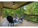 Relaxing covered patio with a ceiling fan and outdoor seating overlooking lush greenery at 3405 Camellia Ln, Suwanee, GA 30024