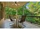 A screened-in porch with a tile floor includes a ceiling fan and furniture for outdoor relaxation at 3405 Camellia Ln, Suwanee, GA 30024