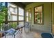 This screened porch features a tile floor with seating, offering a cozy spot to enjoy views of the home's exterior at 3405 Camellia Ln, Suwanee, GA 30024