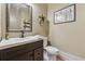 Stylish powder room with dark wood vanity, decorative mirror and neutral decor at 3405 Camellia Ln, Suwanee, GA 30024