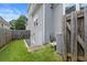 Side yard of a home featuring a well-kept lawn and access to a basement utility entrance at 170 Shelli Ln, Roswell, GA 30075