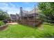 The backyard boasts a wooden deck, climbing wall, stone patio, and lush green lawn at 170 Shelli Ln, Roswell, GA 30075