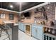 Finished basement bar area features custom cabinetry, wine cooler, and exposed brick walls at 170 Shelli Ln, Roswell, GA 30075