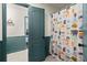 Bathroom with a colorful shower curtain and blue trim at 170 Shelli Ln, Roswell, GA 30075