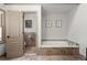 Bathroom featuring a soaking tub with tile surround at 170 Shelli Ln, Roswell, GA 30075